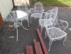 A glass and metal five piece set of garden furniture