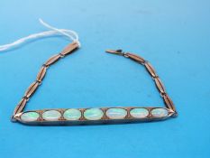 A yellow metal bracelet set with seven opals