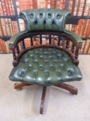 A leather upholstered Captain's chair