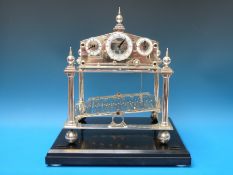 A 20th century silver plated Congreve type rolling ball timepiece with fusee movement,