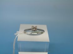 A platinum ring set with a round brilliant cut solitaire diamond of approximately 0.