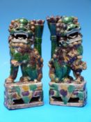 A pair of Chinese Kangxi (1662-1722) famille verte Foo Dogs