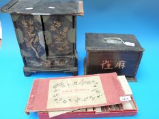 A cased bone and bamboo Mah Jong set together with a similar wooden boxed set and a Japanese