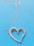 A 9ct white gold heart shaped pendant on a chain marked 375