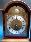 A Dutch chime Elliott bracket clock with brass dial and cherub spandrels including bracket shelf