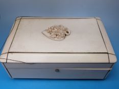 A 19thC ivory box raised on turned legs, with relief carved decoration of flowers,