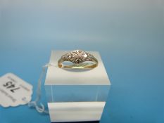 A yellow metal ring marked 18ct set with four diamonds in a platinum setting (size O)