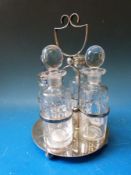A silver plated four bottle cruet with cut glass bottles