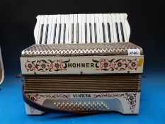 A Hohner 'Vineta' c1930s 48 bass piano accordion in white finish with floral and foliate decoration