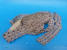 A length of dress maker's braid in silver and mauve thread,