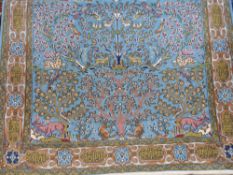 A Persian wool carpet on blue ground with tree of life decoration (L210 x W148cm)