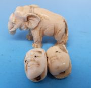 Two Japanese ivory beads in the form of masks and an ivory elephant