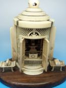 A finely carved Chinese ivory shrine, the interior with a figure of Guanyin,