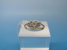 An 18ct gold Art Deco ring set with seven diamonds in an oval platinum / white gold setting (size