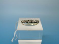 A yellow metal ring set with eight diamonds in a platinum setting (size R)