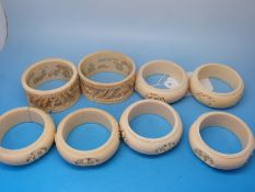 A set of six Chinese ivory napkin rings together with two further napkin rings with reticulated