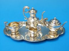 An Edwardian hallmarked silver miniature or dolls tea set on tray with hot water jug, teapot,
