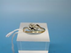 A yellow metal ring marked 18ct set with two diamonds in a platinum setting (size R)