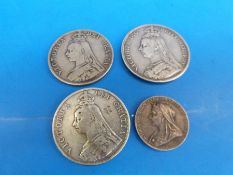 An 1889 Victorian crown together with two Victorian double florins and a commemorative 'young head