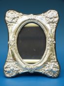 A hallmarked silver oval photograph frame with stand to rear (maximum diameter of aperture 12.