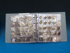 An amateur world coin collection in a Smith's album