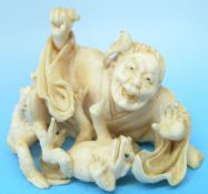 A 19thC Japanese ivory okimono of an old man grappling with two toads