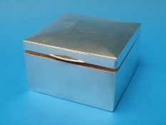 A square hallmarked silver cigarette box, B'ham 1911,