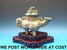 A Chinese jadeite large tripod teapot and cover with coiled dragon finial,
