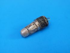 A white metal filigree needlework etui comprising thimble and tape measure