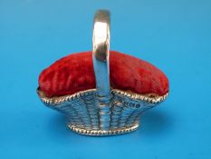 A hallmarked silver pin cushion in the form of a basket, B'ham 1910,