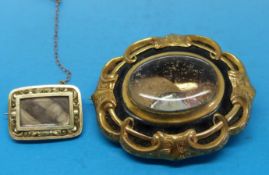 A Victorian gold mourning brooch with chased gold decoration to the mount and large glass
