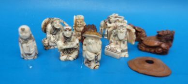 A collection of oriental netsukes etc to include cherry wood example