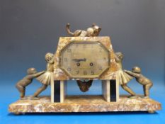 An Art Deco marble clock decorated with spelter children trying to reach a kitten