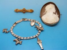 A yellow metal brooch marked 15ct set with diamonds and a ruby,