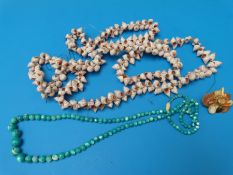 A large shell necklace and a beaded mother of pearl turquoise necklace