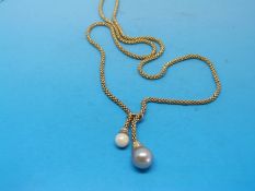 An 18ct gold rope style necklace set with two large pearls, one grey in colour,