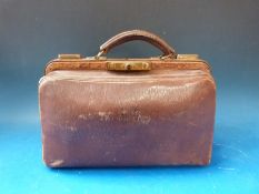 A small leather Gladstone bag