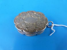 A Victorian vinaigrette mounted on a loop, of oval form with pierced inner cover,