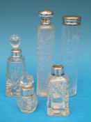Four hallmarked silver mounted dressing table bottles together with a plated mounted example