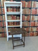 A painted shelf unit together with an occasional table