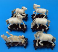 Six Chinese ivory horses on fitted wooden stand