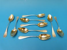 A set of nine French white metal teaspoons with gilt bowls and engine turned handles,