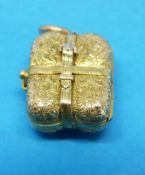 A Victorian pendant in the form of a miniature suitcase with chased decoration and a hair