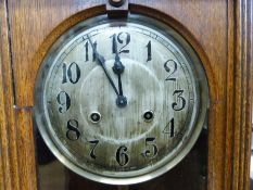 A c1920s oak-cased wall clock,