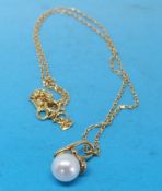 An 18ct gold pendant set with a Mikimoto pearl on an 18ct gold chain,