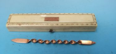 An ivory box decorated with yellow metal inlay with a yellow metal tooth pin inside