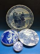 A blue and white Delft charger (40cm diameter) depicting a couple on a horse-drawn sleigh,