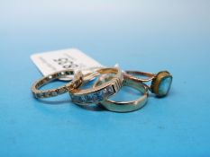 A 9ct gold wedding band, a 9ct gold ring set with six cubic zirconia,