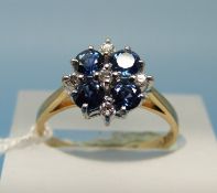 An 18ct gold ring set with four sapphires and five diamonds (size M)