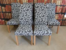 A set of six modern upholstered dining chairs with light oak legs